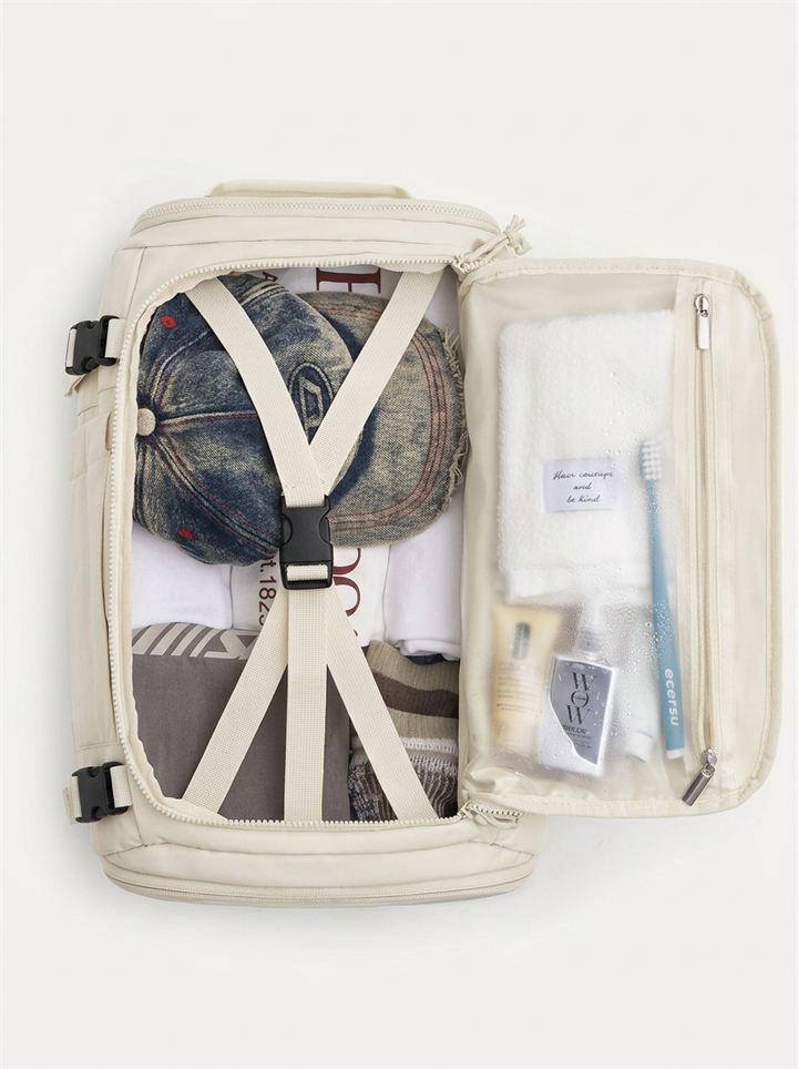 Main compartment opened with compression straps and clear toiletry pouch
